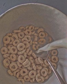 a bowl full of cereal with a spoon in it