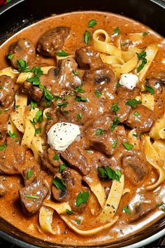 a skillet filled with beef and noodles