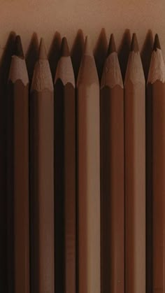 several brown pencils lined up next to each other