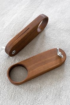 two wooden objects sitting on top of a white cloth