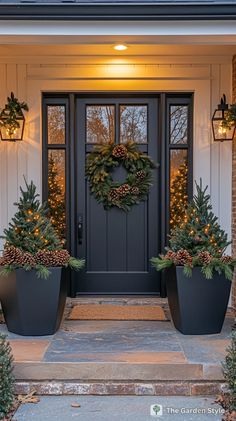 two large planters with christmas wreaths on the front door