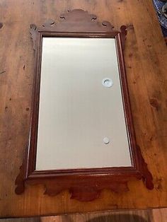 a wooden table with a mirror on it