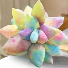 there is a colorful flower made out of colored powders on top of a table