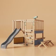 a wooden play set with a slide and ladder