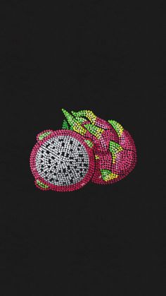 two pieces of fruit with green and pink designs on black fabric that is sequinized