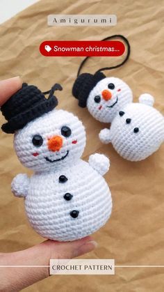 two crocheted snowmen with hats on their heads