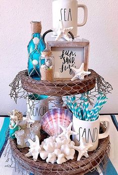 two tiered trays holding cups and seashells on top of each other