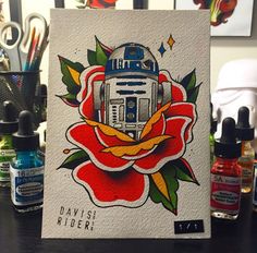 a card with a robot on it sitting on a table next to some pens and markers