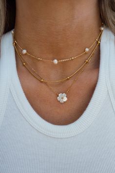 Details: 18K Gold Plated Stainless Steel Gold Beaded Satellite Chain Necklace With Mother of Pearl Flower Sizing: Length of Necklace: approx. 16 - 18 inches (adjustable) White Flower Necklace, Trendy Necklaces 2024, Popular Necklaces, Fall Winter Essentials, Trendy Necklaces, Necklace Sets, Hippie Jewelry, Pretty Jewelry, Pearl Flower