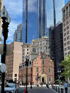 a city street with tall buildings in the background