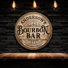 the logo for anderson's bourbon bar on a wooden table in front of brick wall