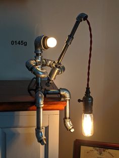 a lamp that is sitting on top of a table next to a framed photo and an old fashioned faucet