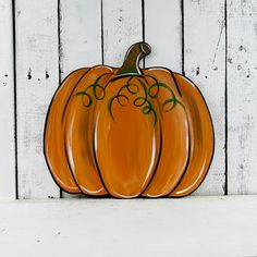 a painted pumpkin sitting on top of a white table