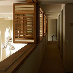 an empty hallway with wooden slats on the windowsill