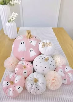 some pink and white pumpkins on a table