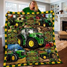 a woman holding up a green and yellow blanket with pictures of farm equipment on it