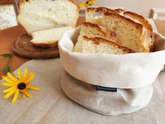 slices of bread sit in a bag on a table next to a flower and a mirror