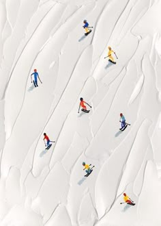 several skiers are skiing down a snowy hill