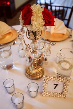 the table is set with candles, flowers and place cards for guests to sit on