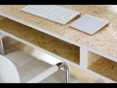 a computer keyboard sitting on top of a wooden desk next to a mouse and keyboard