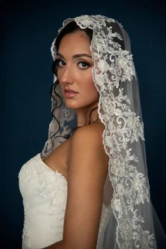 a woman in a wedding dress with a veil on her head