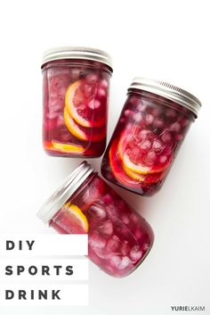 three mason jars filled with red liquid and sliced oranges on top of each other