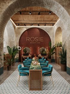 the inside of a restaurant with blue chairs and tables in front of an arched doorway