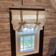 a window with two bows on the valance