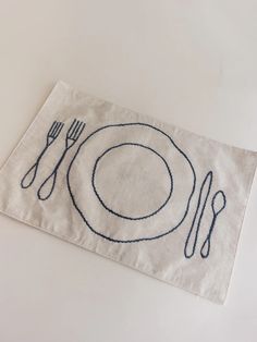 a place mat with a fork and knife on it