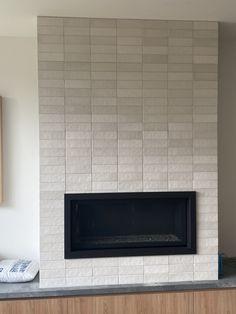 a fireplace in a living room next to a wall with a clock on it's side