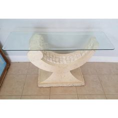 a glass table with a white chair on it