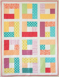 a colorful quilt with squares and dots on it