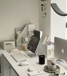 an apple computer sitting on top of a white desk