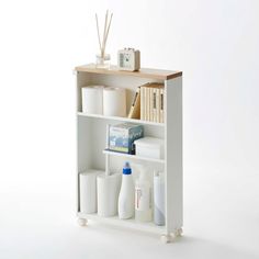 a white shelf with various items on it