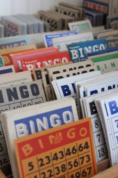 many different types of playing cards are stacked together on top of each other in a bin