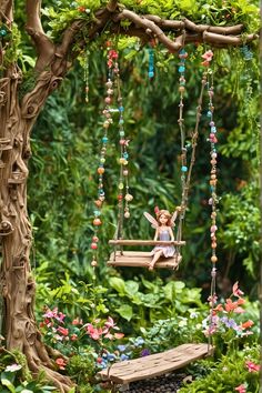 a doll is sitting on a swing in the garden