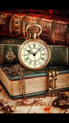 an old pocket watch sitting on top of books in a wooden frame with chains around it