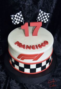 a birthday cake with the number 17 on it and checkered flag decorations is shown