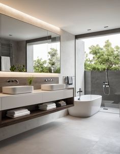 a modern bathroom with two sinks and a bathtub in the middle, along with a large window