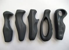 five different types of black handles on a white surface