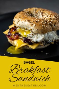 a bagel breakfast sandwich on a black plate