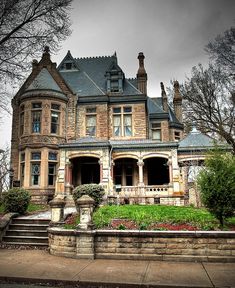 an old victorian style house with stone steps leading up to it