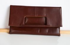 Simply elegant vintage 2 in 1 made in Montreal Canada signed ''Chic'' reddish-brown leather women purse convertible clutch or handbag with one external pocket which closes with a zipper. The interior linen is in brown faux suede. 10 x 10 x 0.5 inches when worn as a handbag and 10 x 5-3/4 x 7/8 inches when worn as a clutch. As shown in the picture, this purse can be worn as clutch or as handbag Good condition with very clean interior and minor surface scratches due to storage and minor discoloration of the brown color on the corners on the bottom -  sold as is -return not accepted. Very solid built - this purse was worn a couple of times only. To make this a smooth and pleasant transaction experience for everyone, all buyers need to read and understand the description, the terms of sale , t Travel Clutch In Soft Brown Leather, Brown Soft Leather Clutch For Travel, Brown Rectangular Clutch For Everyday Use, Brown Satchel Clutch, Vintage Everyday Clutch With Removable Pouch, Brown Travel Clutch With Detachable Strap, Brown Leather Clutch For Daily Use, Brown Formal Satchel With Magnetic Closure, Formal Brown Satchel With Magnetic Closure