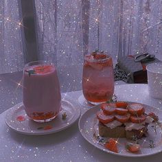 two plates with desserts and drinks on them sitting on a table in front of a window