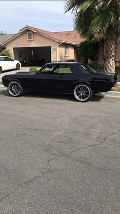 a black car parked in front of a house