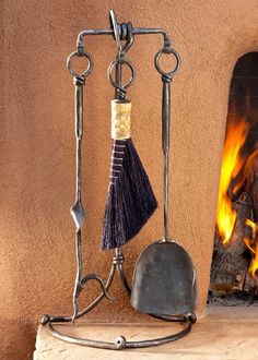 a fireplace with a fire in the background and some cooking utensils on it