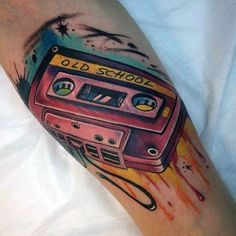 an old school tattoo on the arm of a person with a boombox and headphones