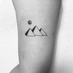 a black and white photo of a mountain tattoo