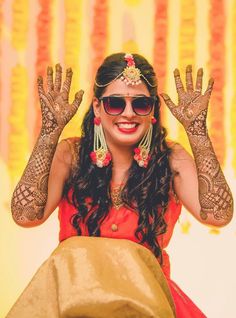 a woman with her hands in the air and wearing hendikes on her head