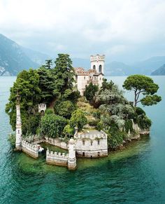 an island in the middle of water surrounded by trees